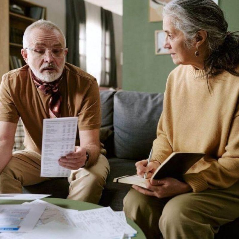A couple sits on a couch reviewing