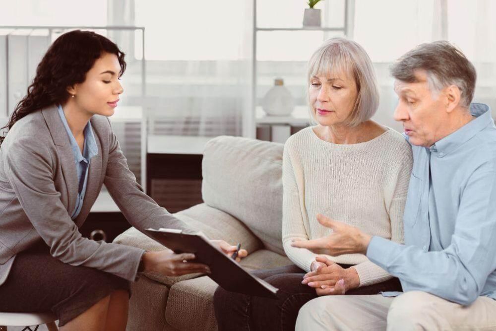 A couple sitting on a couch discussing legal advice