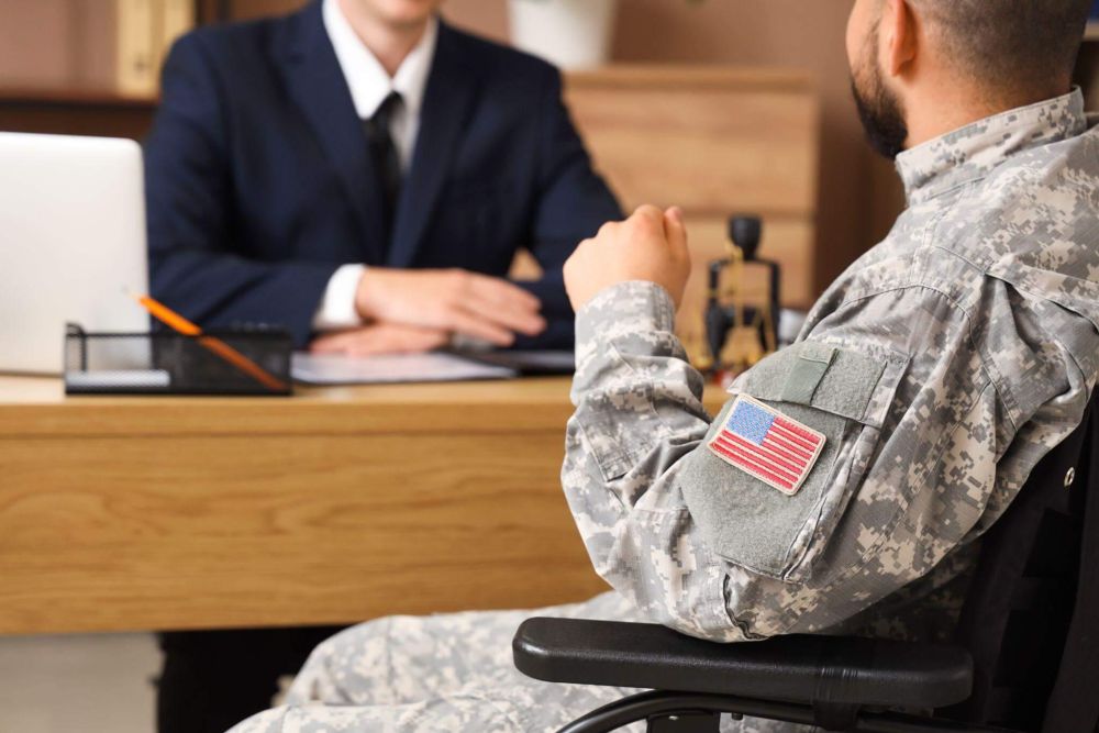 a man in a military uniform sitting in front of a laptop computer and a lawyer