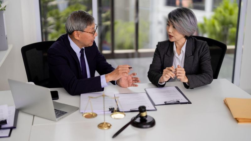 Two people sitting at a table discussing probate