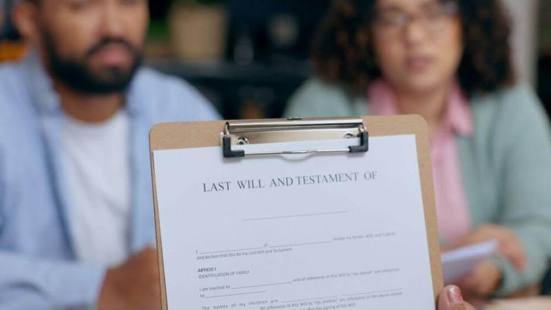 Man and woman discussing legal documents with a clipboard