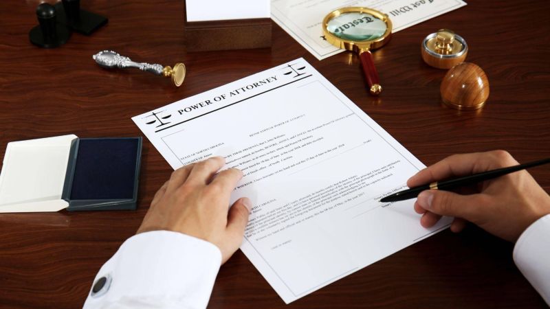 a person writing on a piece of paper