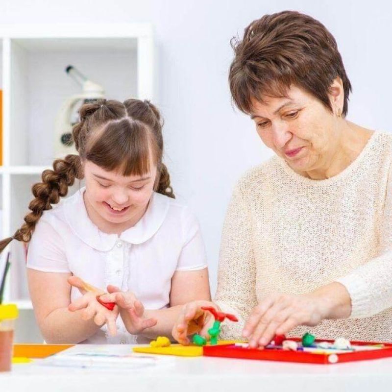 Older woman and young girl playing with toys