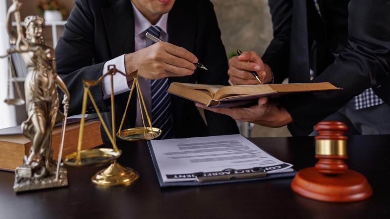 Man in a suit writing at a desk