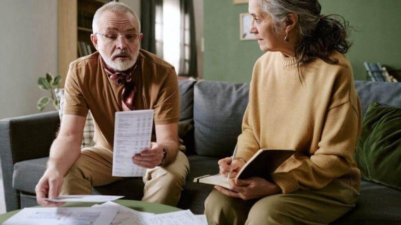 A couple sits on a couch reviewing