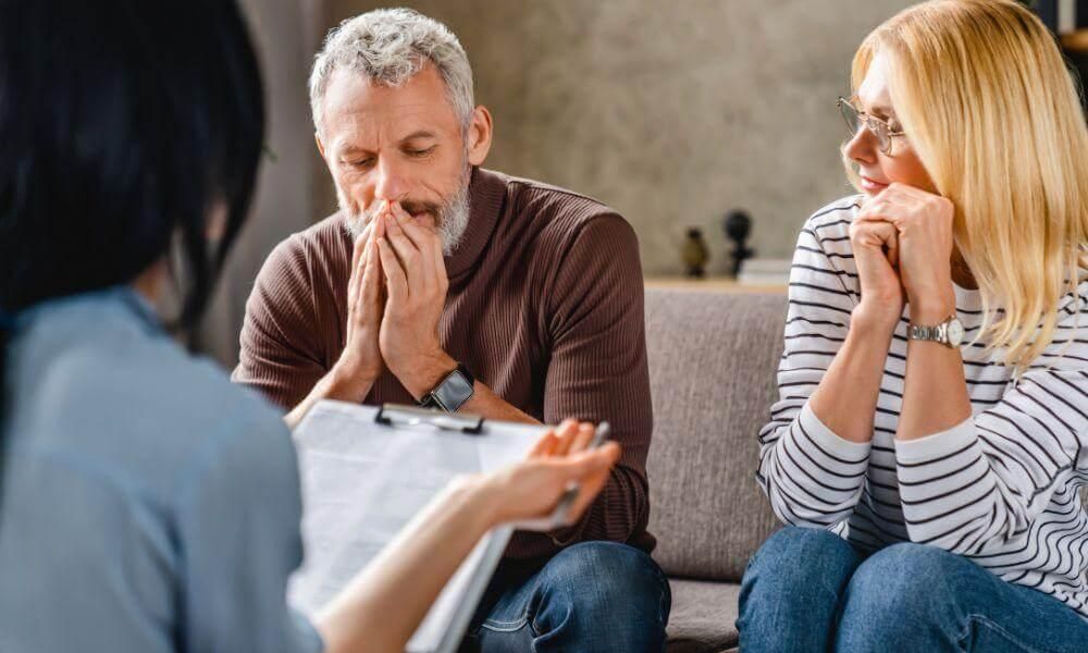 Client and legal advisor discussing probate on a couch