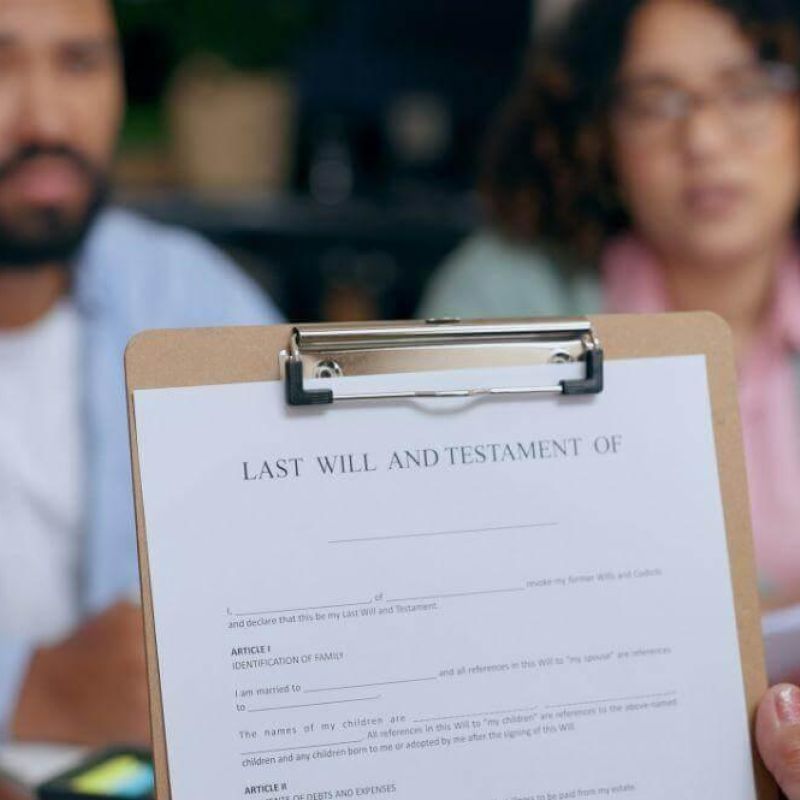 Man and woman discussing legal documents with a clipboard
