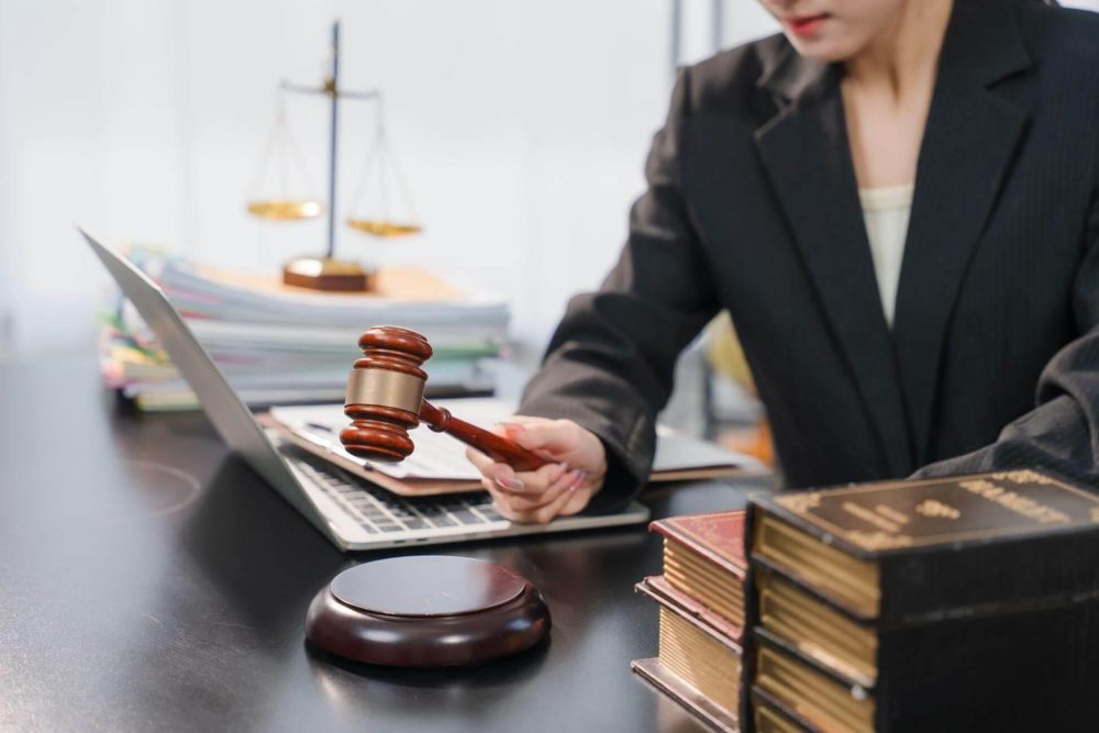 Woman at desk with laptop, potentially reviewing estate planning