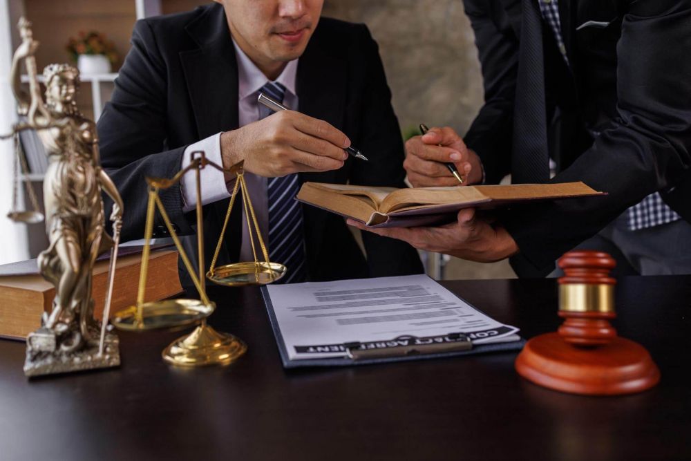 Man in a suit writing at a desk