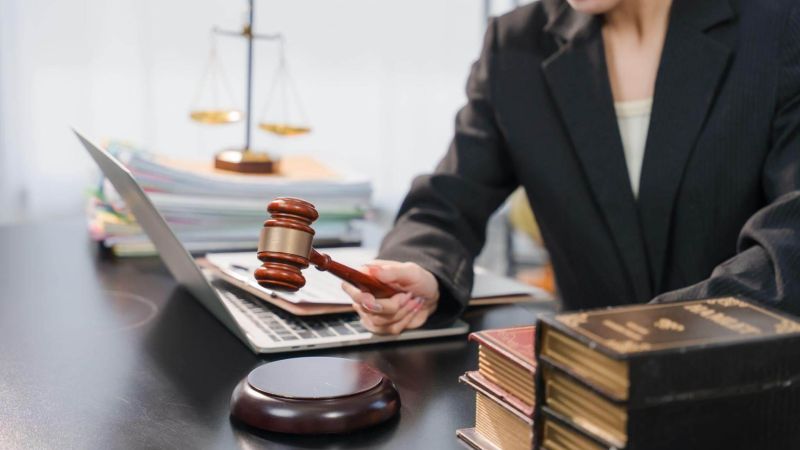 Woman at desk with laptop, potentially reviewing estate planning