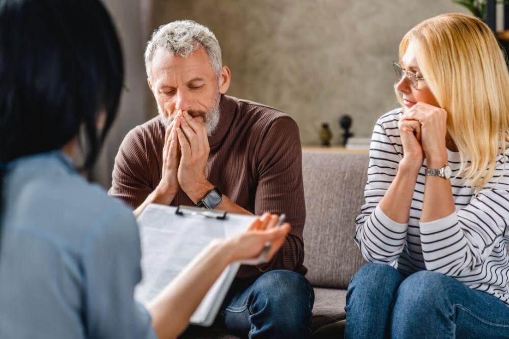Client and legal advisor discussing probate on a couch