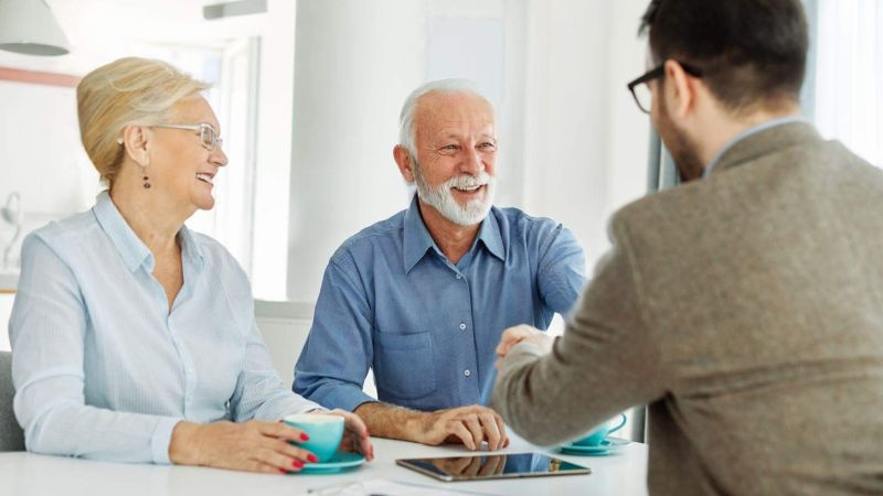 Two people discussing elder law with an attorney