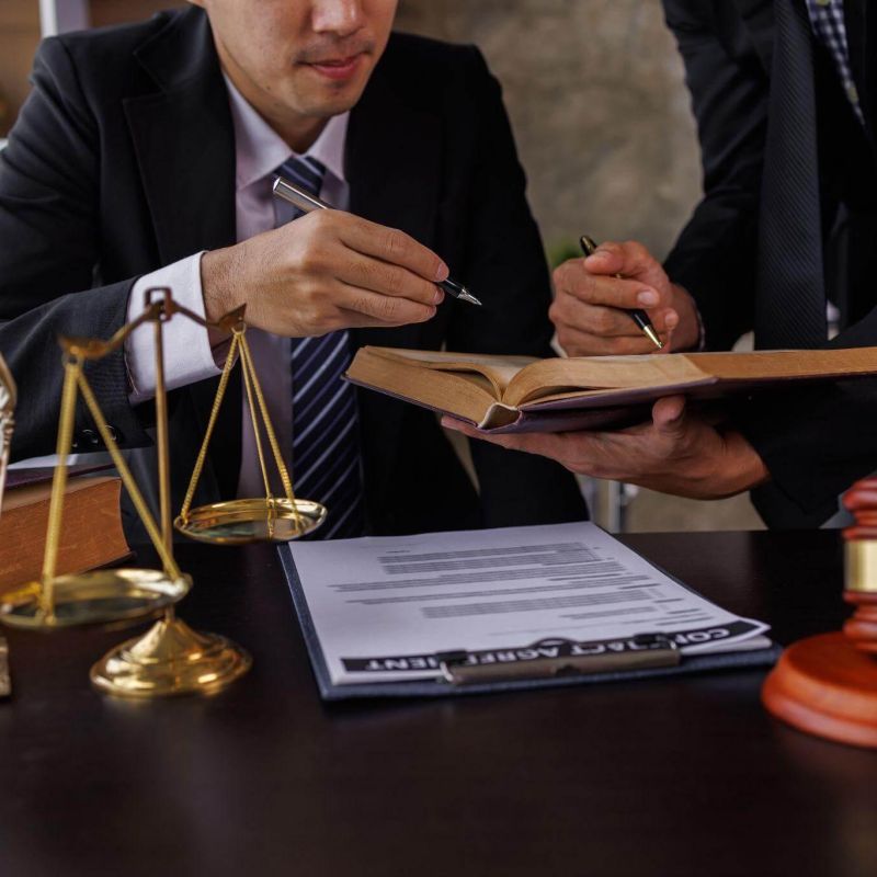 Man in a suit writing at a desk