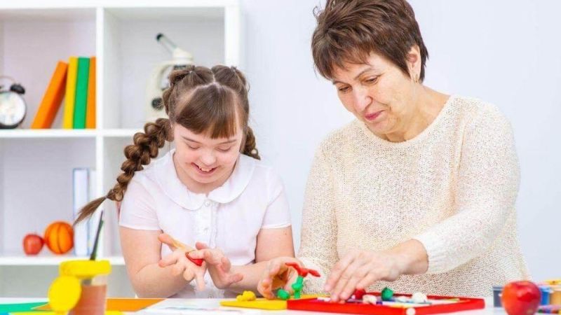 Older woman and young girl playing with toys