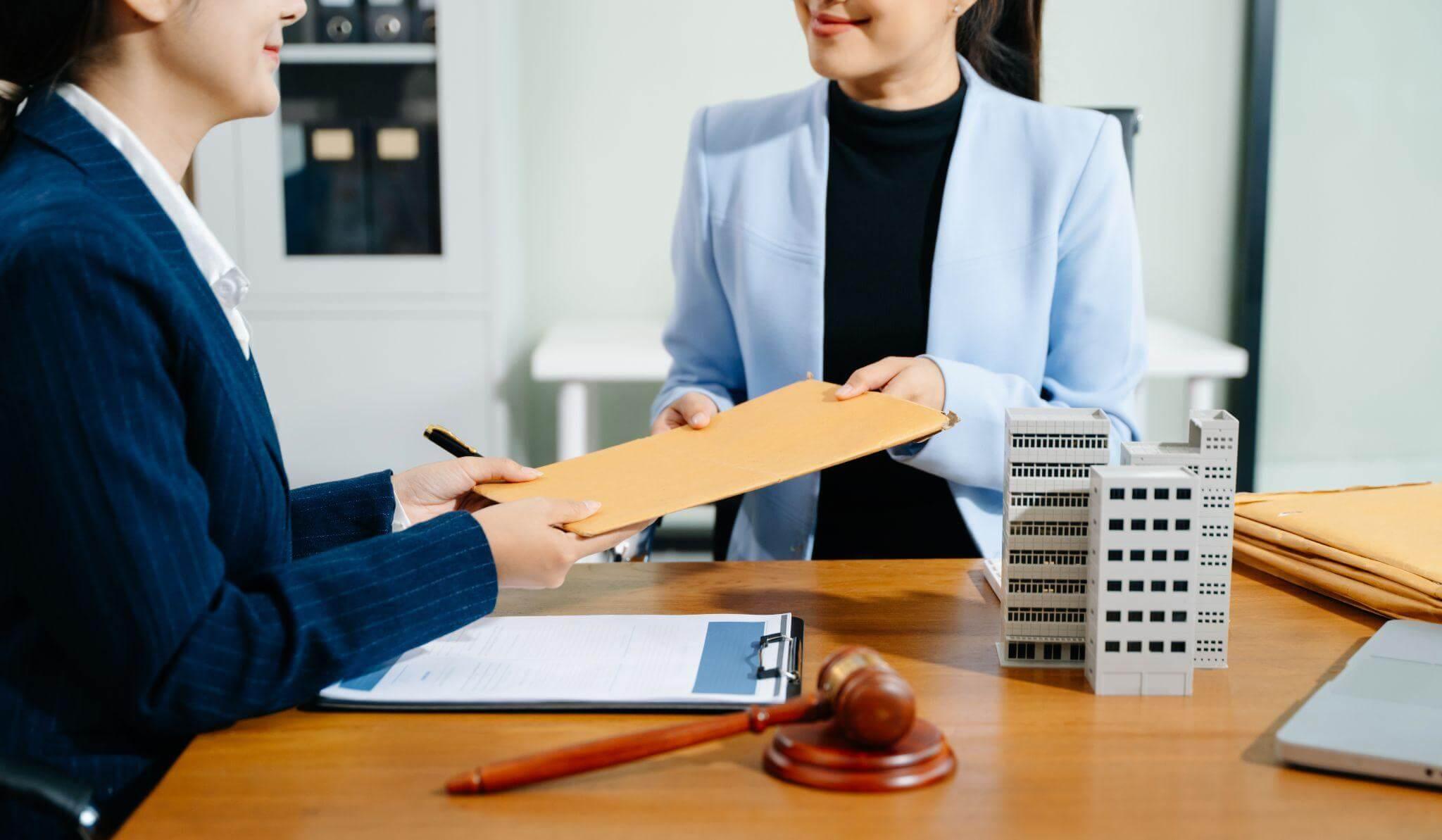 two women sitting at a table with a piece of paper in front of them