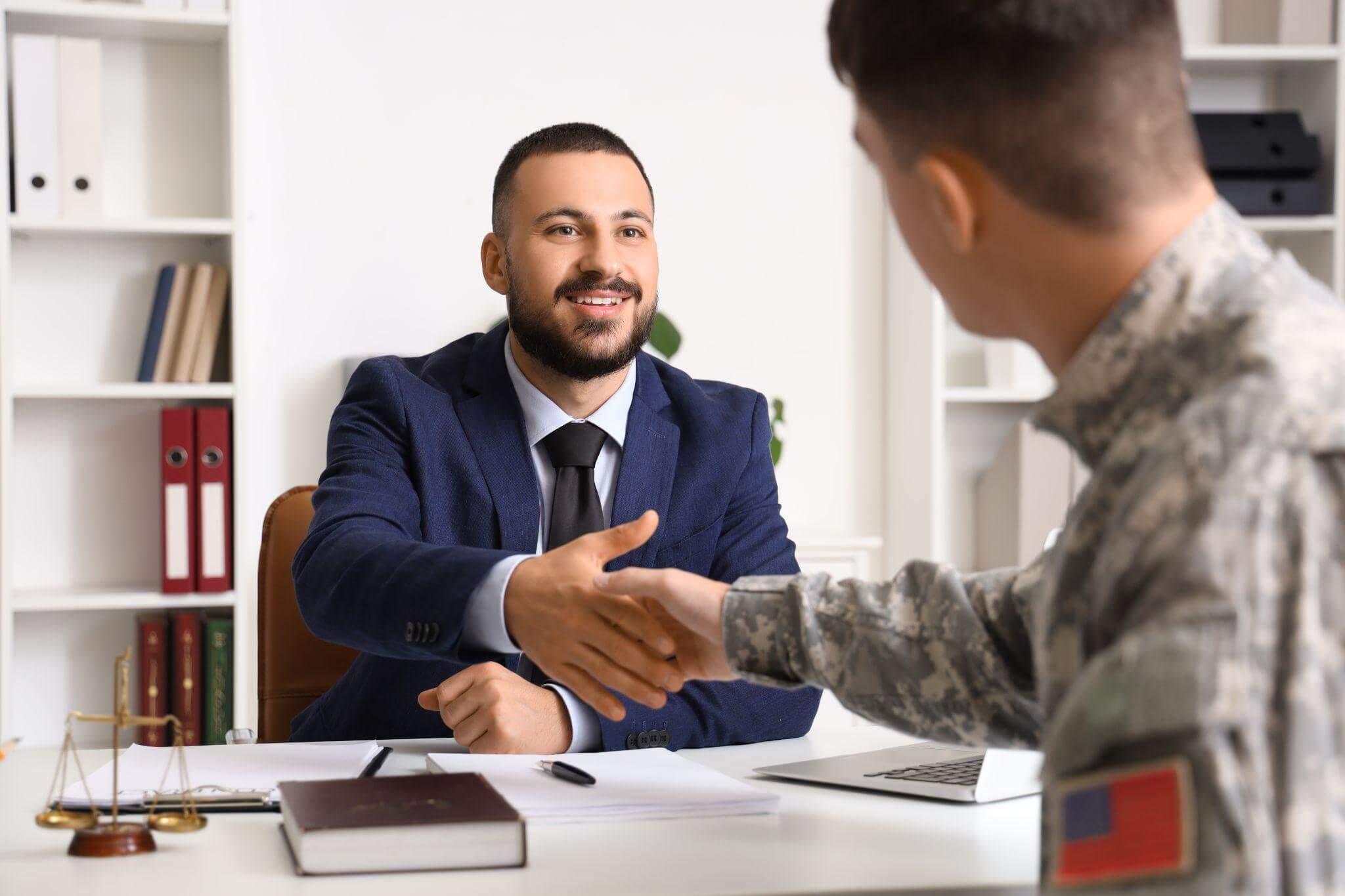 a soldier shaking hands with a man in a suit