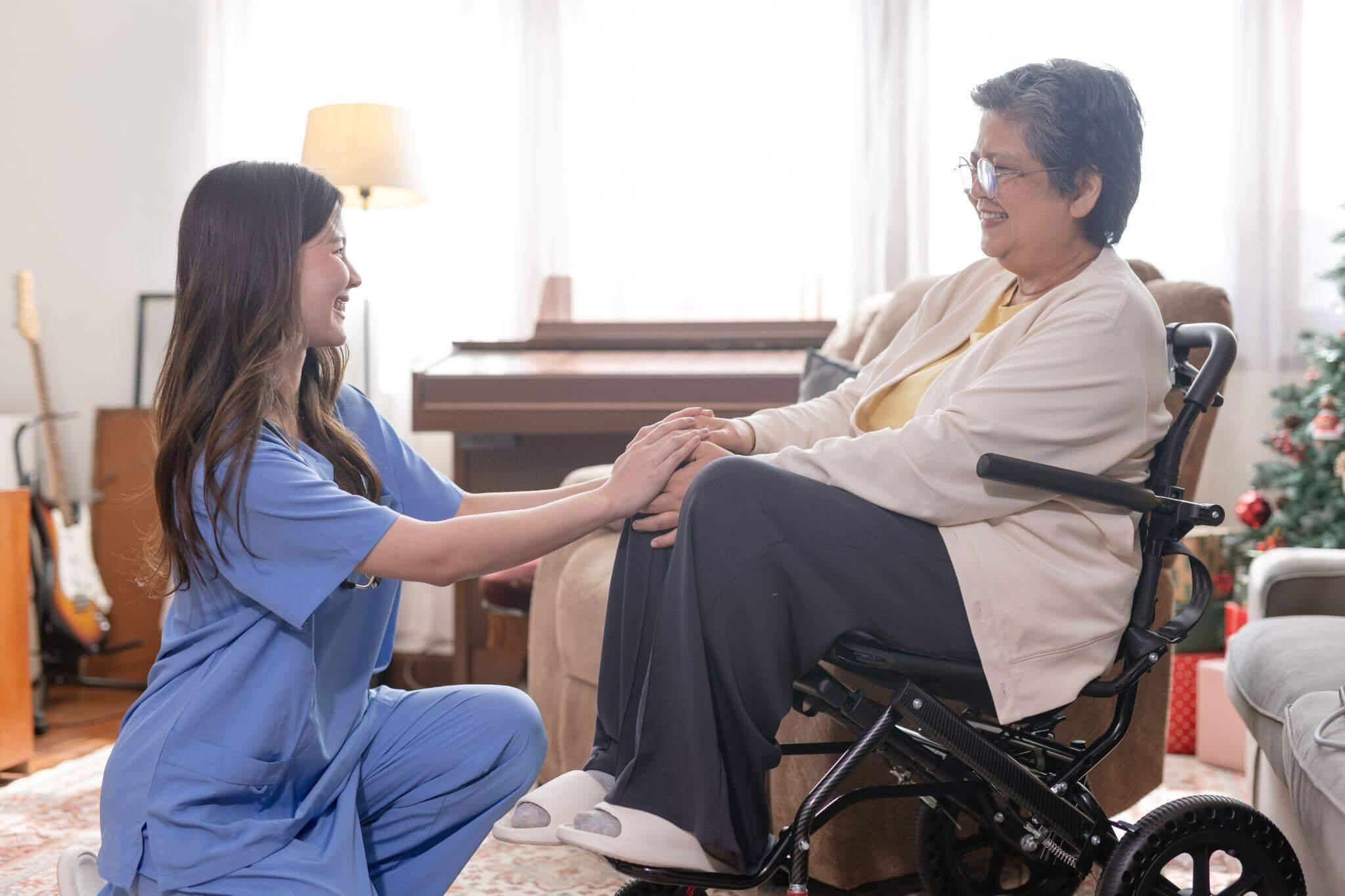 a woman in a wheelchair shaking hands with another woman