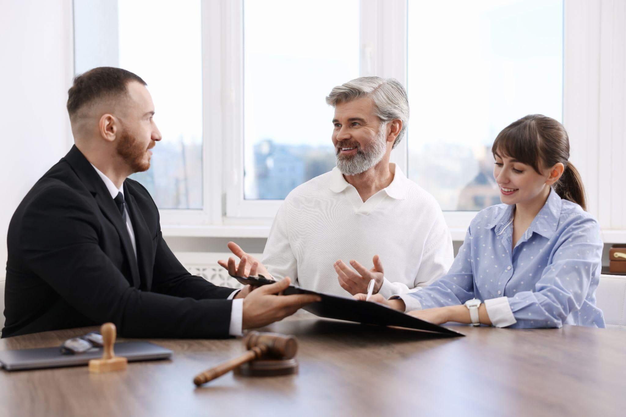 Group of people gathered around a wooden table discussing VA