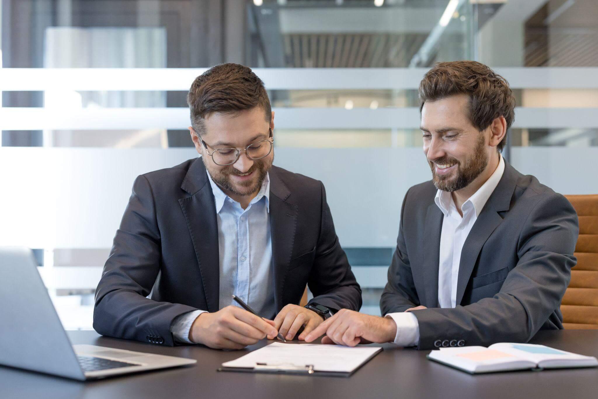 Two men reviewing documents related to a power of attorney