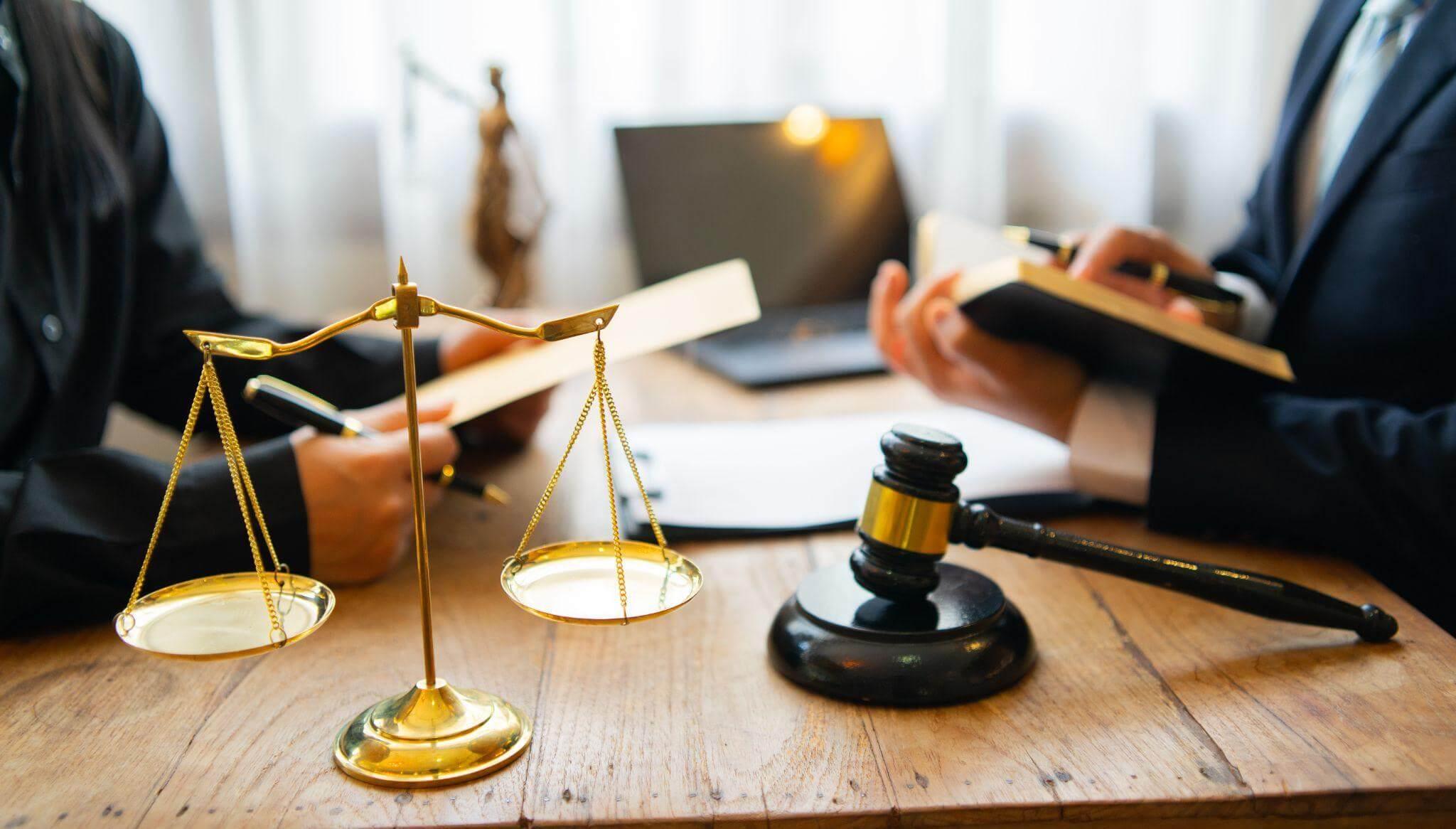 Two people at a table with a judge