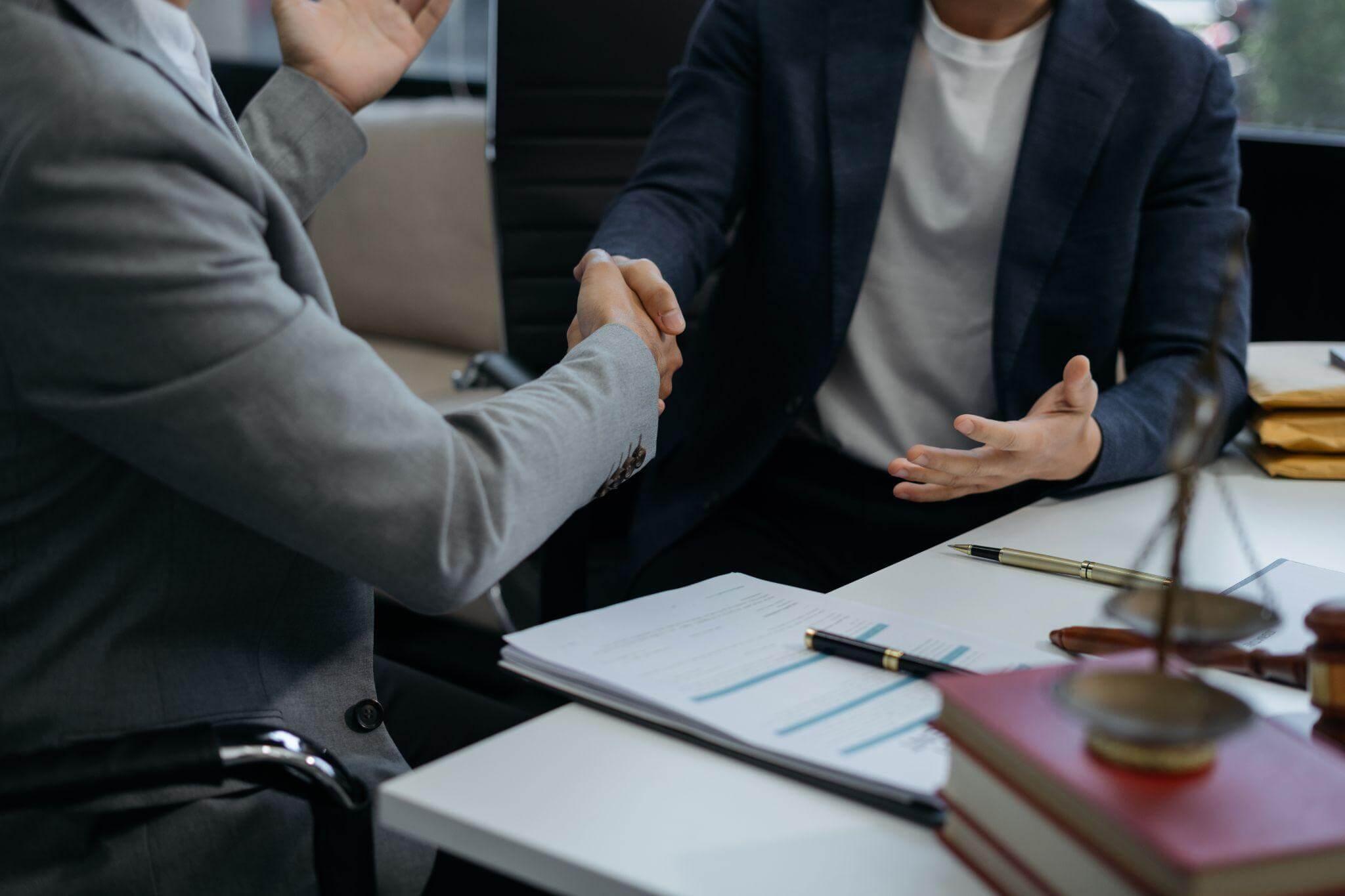 Two people shaking hands in an office