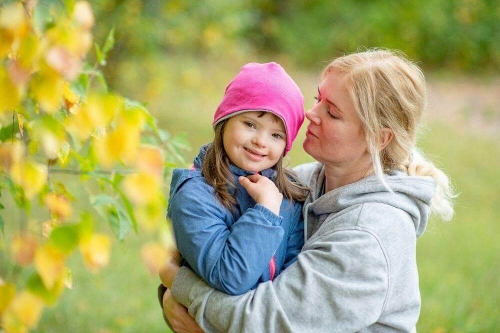 Woman holding a little girl, symbolizing family in special
