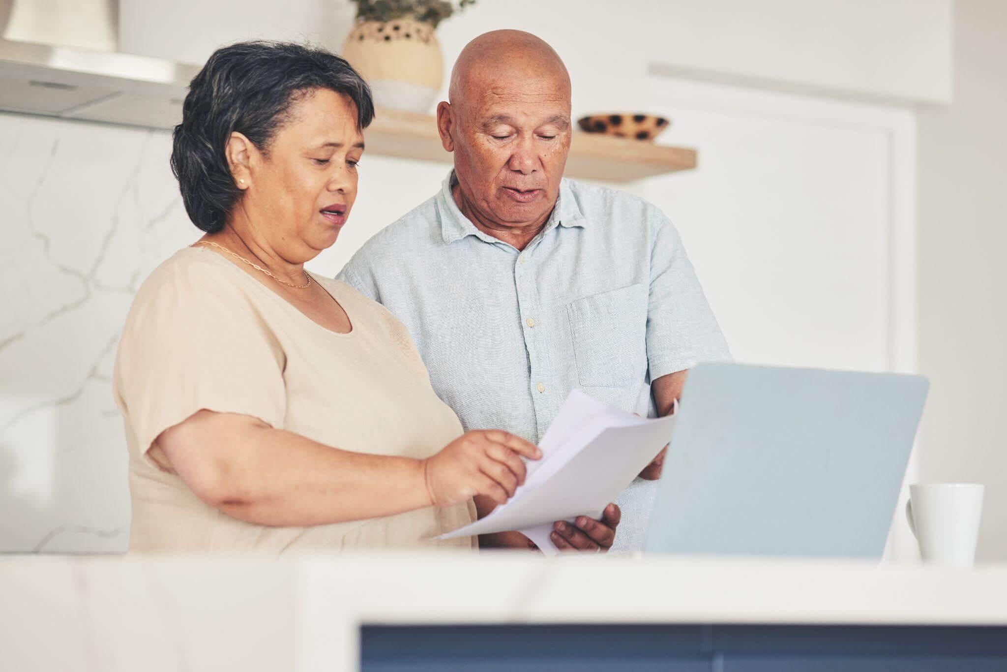 Man and woman reviewing Medicaid planning documents