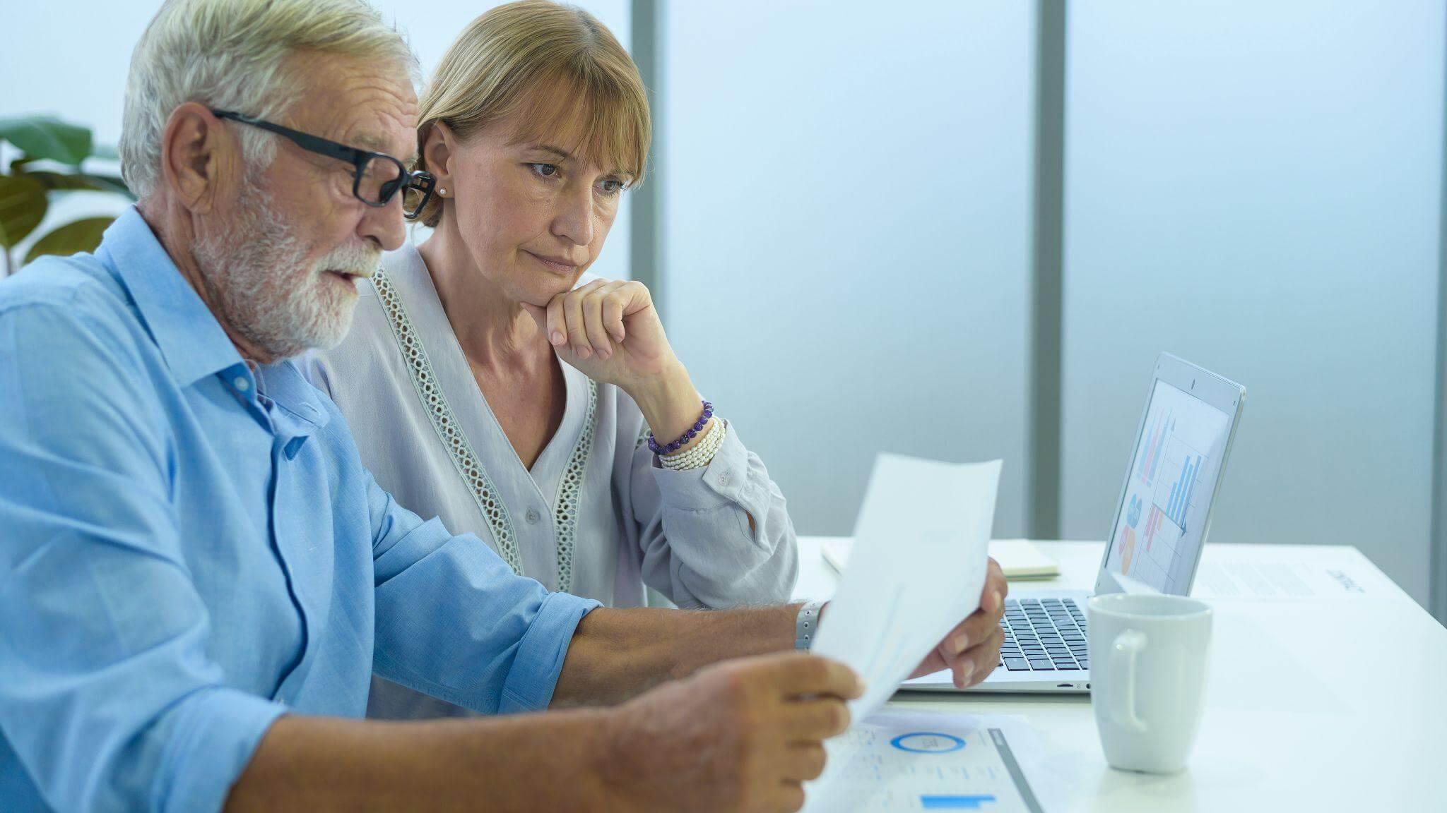 Man and woman reviewing Medicaid planning on a laptop