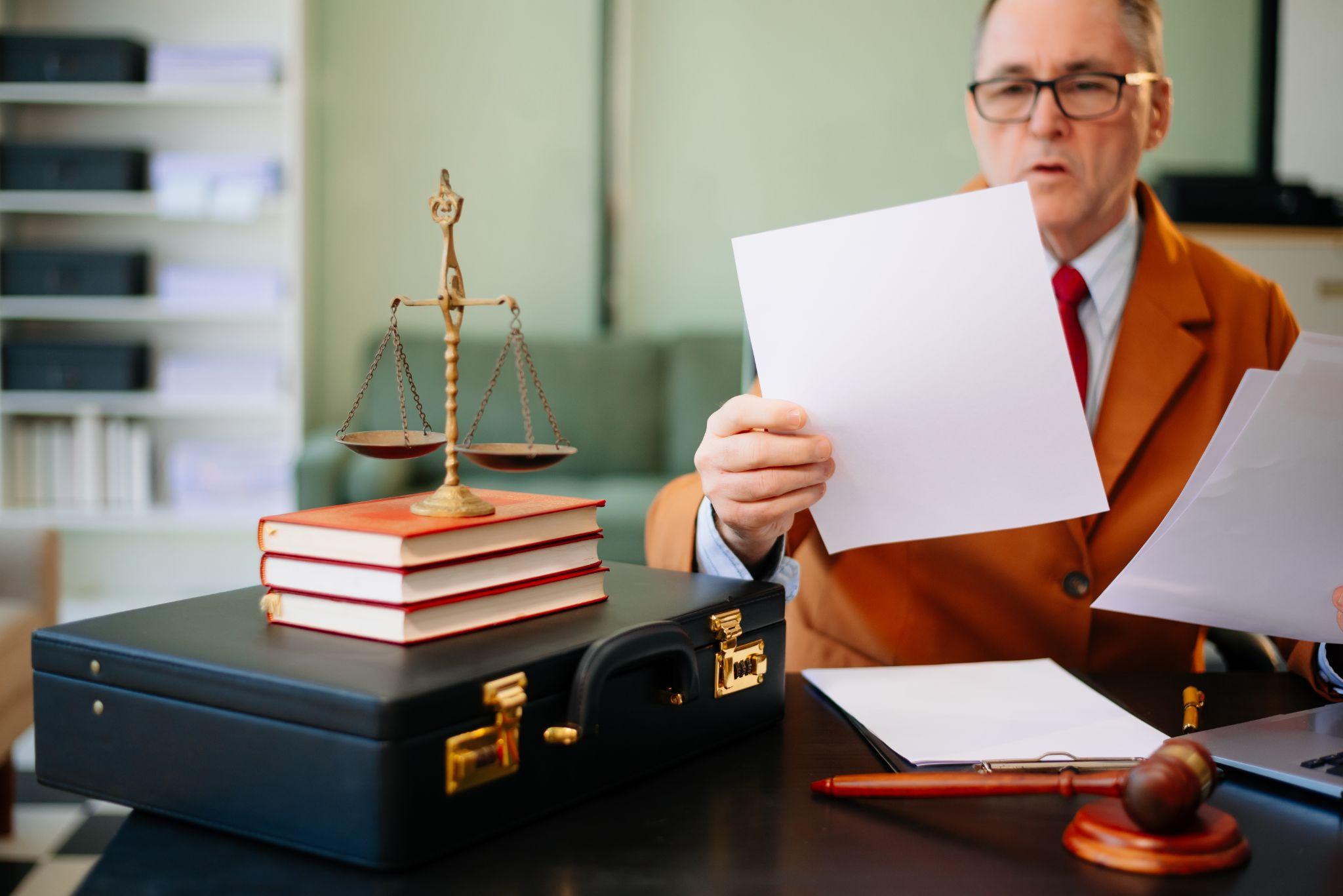 Man at desk reviewing documents on how to