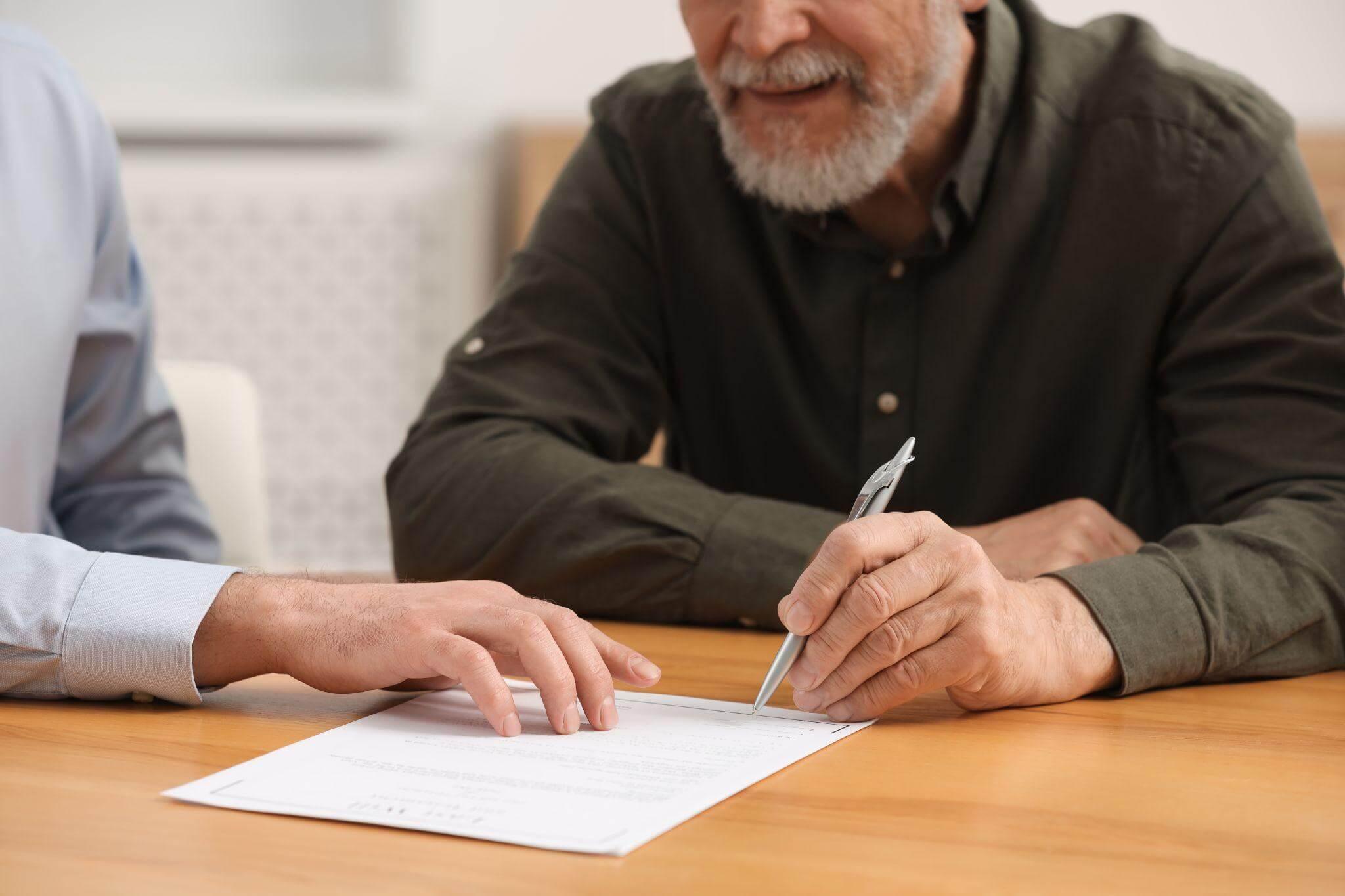 Man signing an important document during the probate