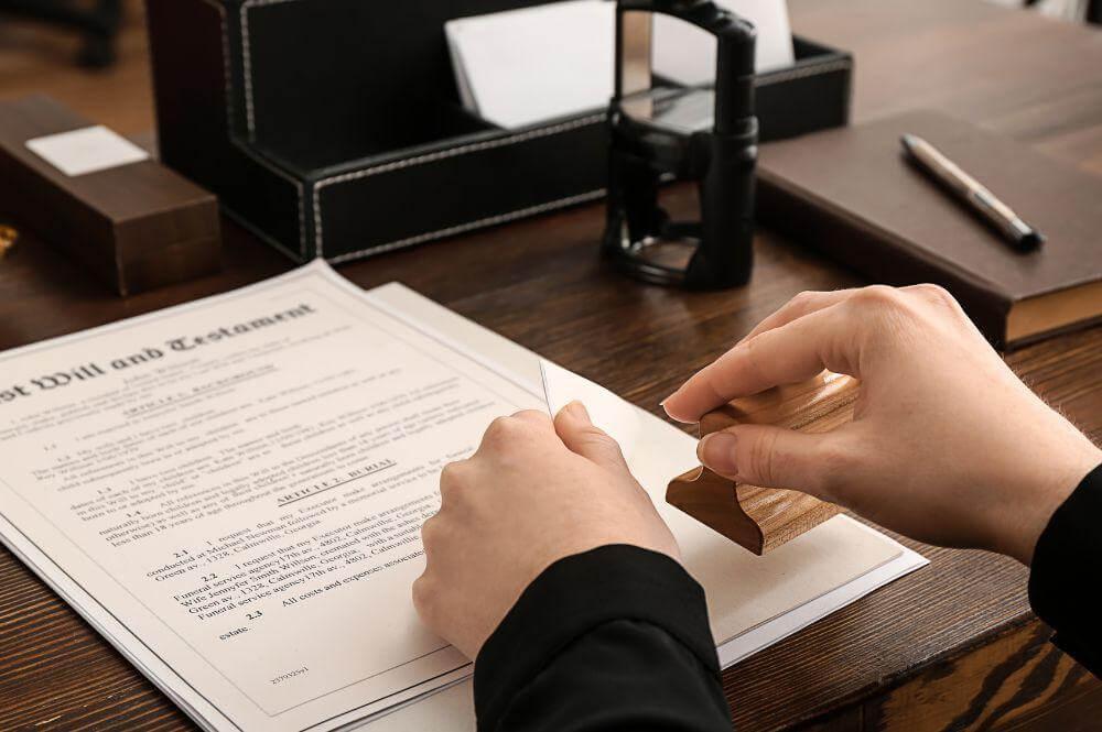 Person writing notes during a will consultation