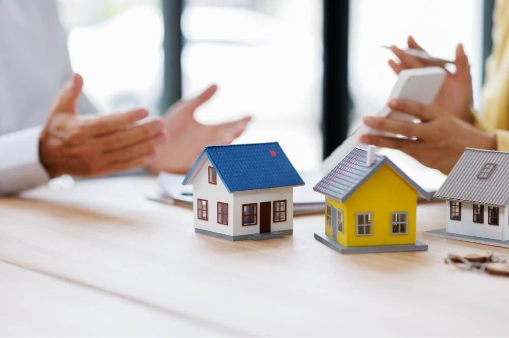 People discussing small house models representing probate